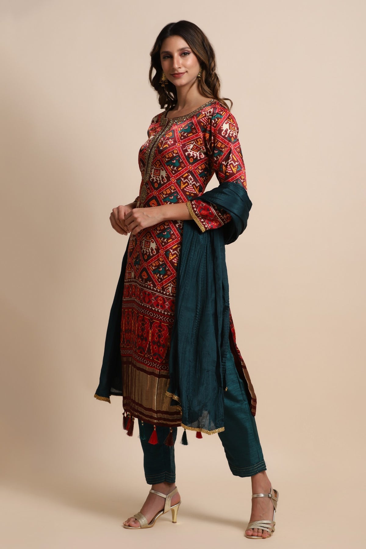 Red patola suit with embroidery on neckline paired with peacock blue pants and peacock blue dupatta