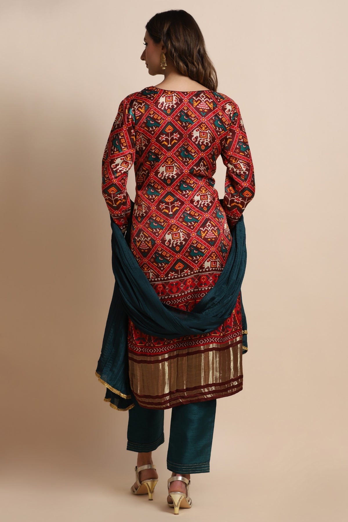 Red patola suit with embroidery on neckline paired with peacock blue pants and peacock blue dupatta