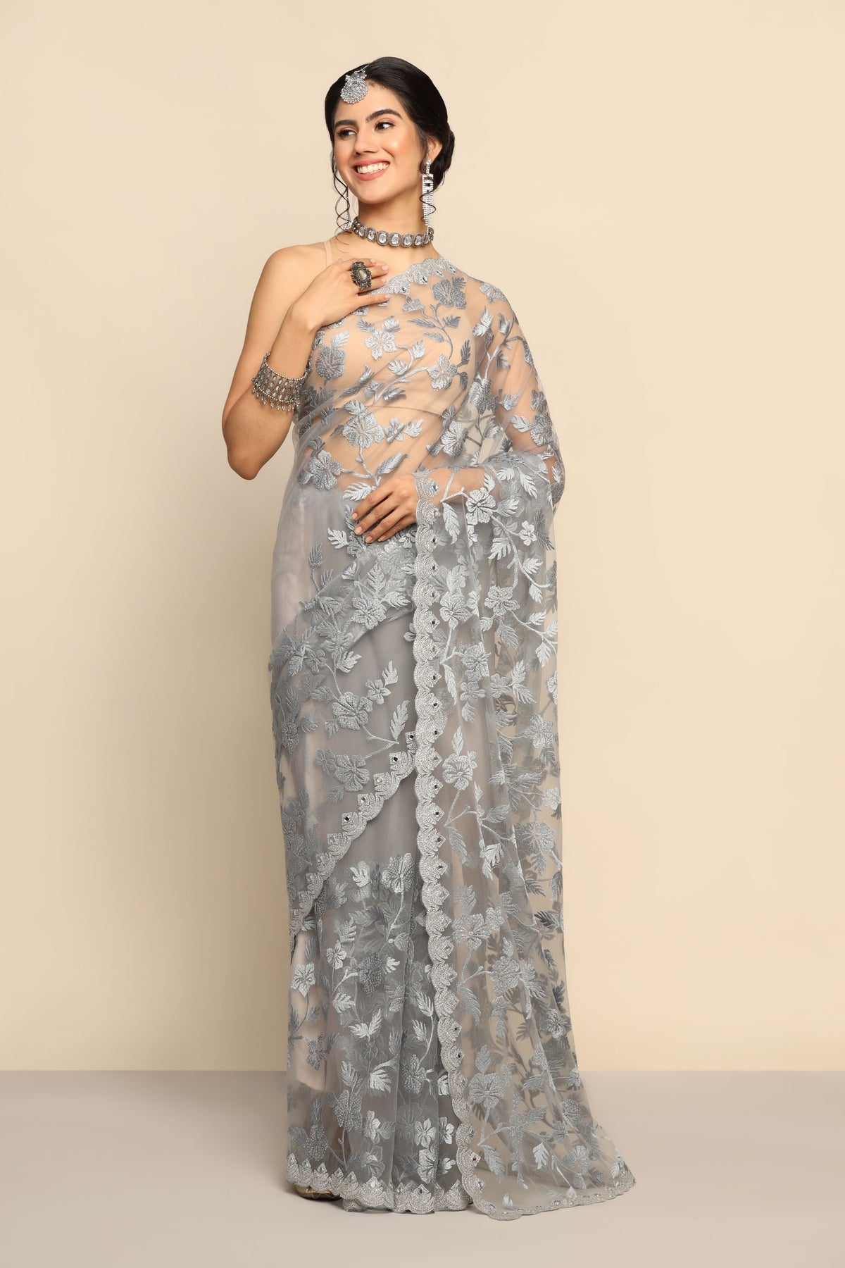 Graceful Grey Net Saree with Intricate Thread Work and Sparkling Sequins